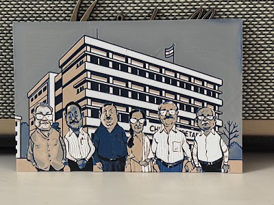Rectangular 3D-printed plaque of six colleagues standing before a secretariat building.