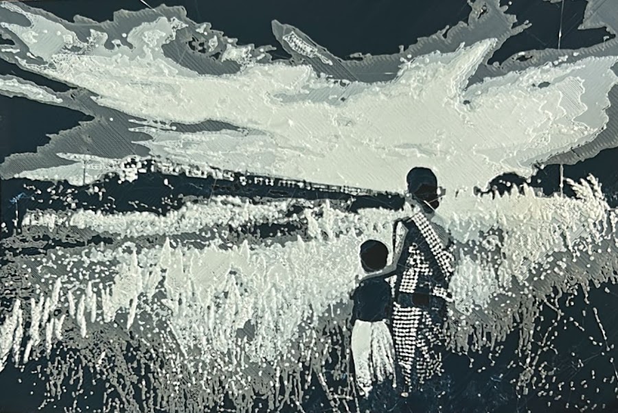 3D-printed plaque of a mother and child in a field.